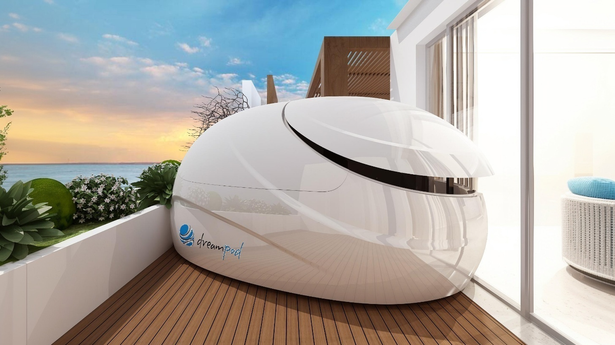 Dreampod V2 float pod commercial float tank installed on outdoor deck at modern home overlooking ocean environment