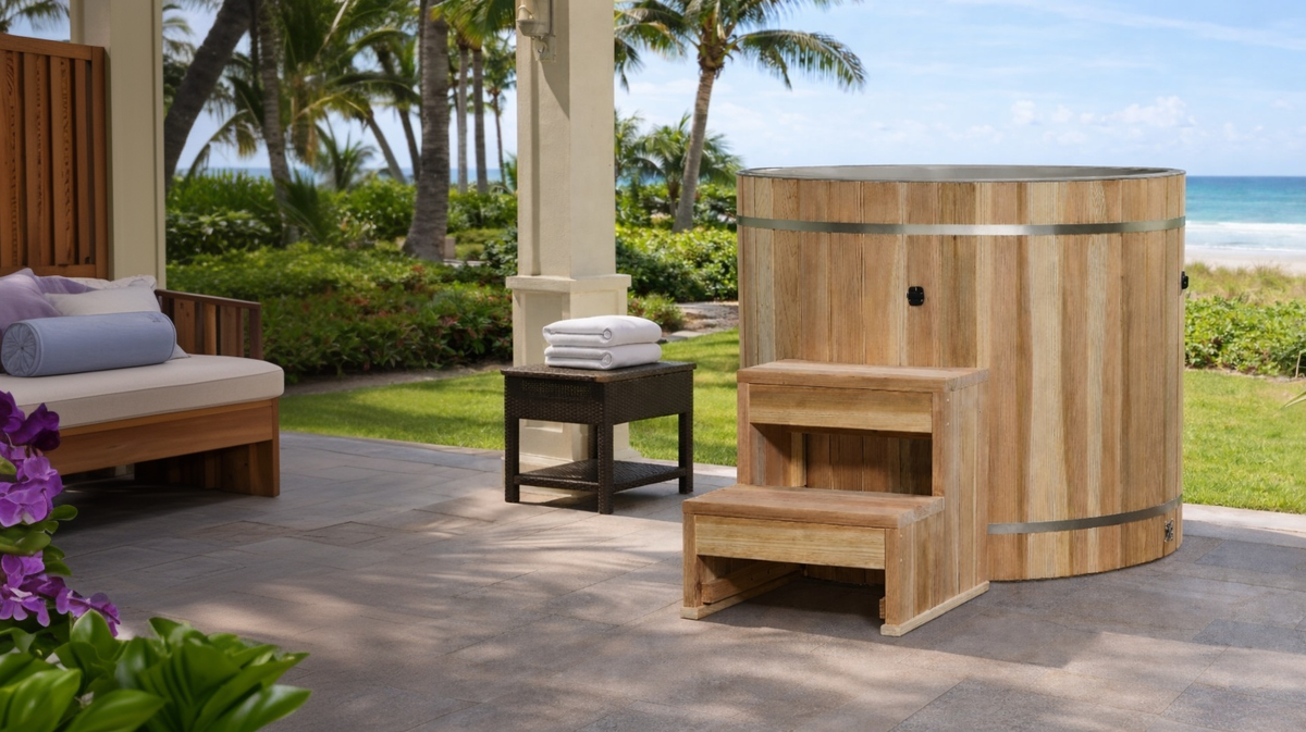Dynamic Cold Therapy barrel cold plunge tub placed on outdoor patio with ocean view and tropical landscape setting