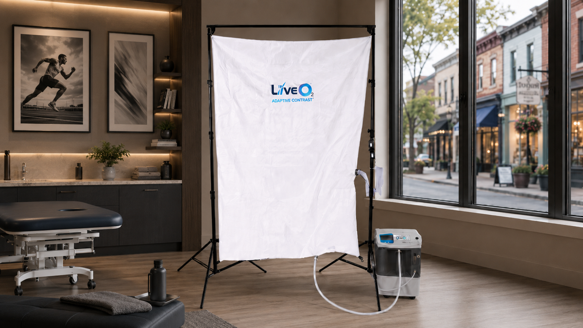 LiveO2 Adaptive Contrast EWOT system with reservoir and air separator in a clinic wellness room with main street window view
