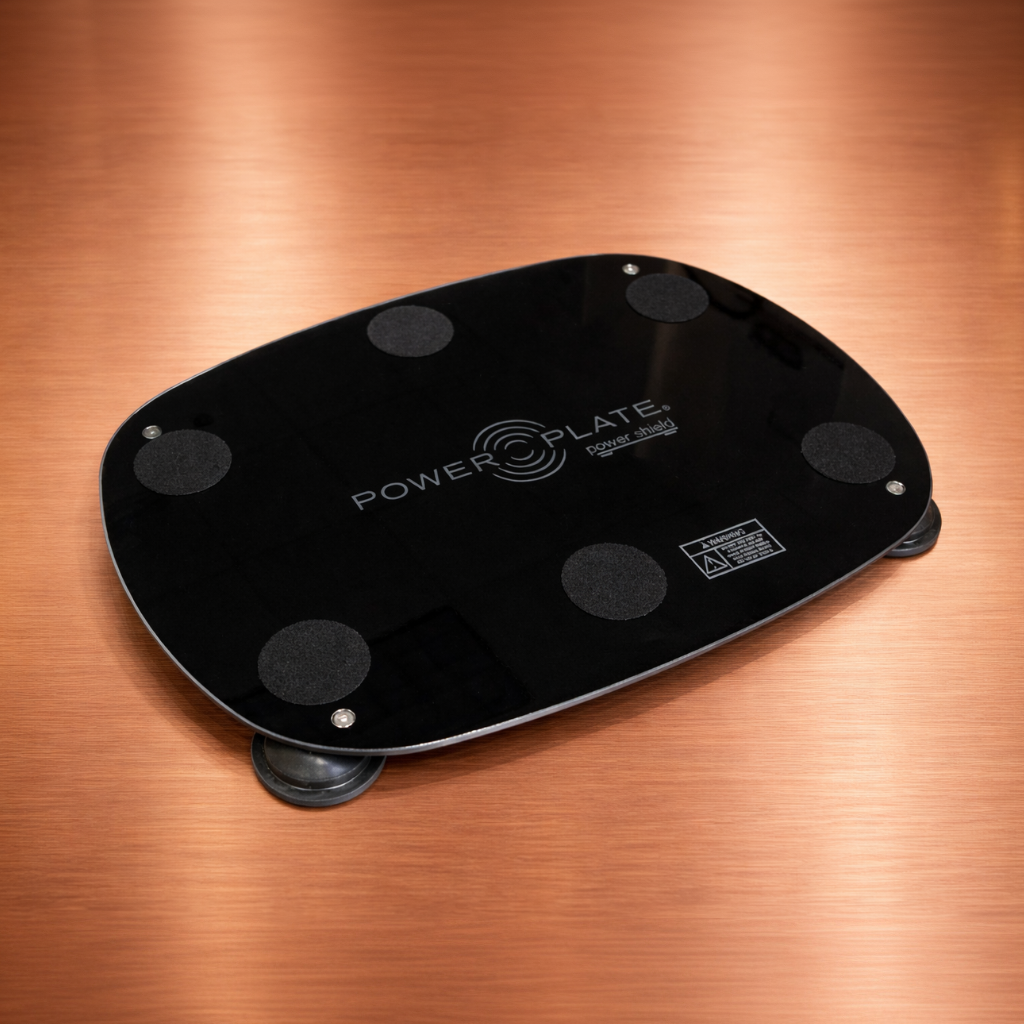 Close angle view of the Personal Power Plate Power Shield vibration reduction platform showing the low-profile design used beneath the Personal Power Plate to help absorb vibration and reduce transmitted movement through flooring.