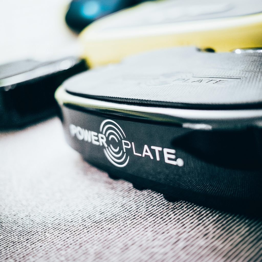 Close-up detail of Personal Power Plate vibration platform showing textured training surface and Power Plate branding.