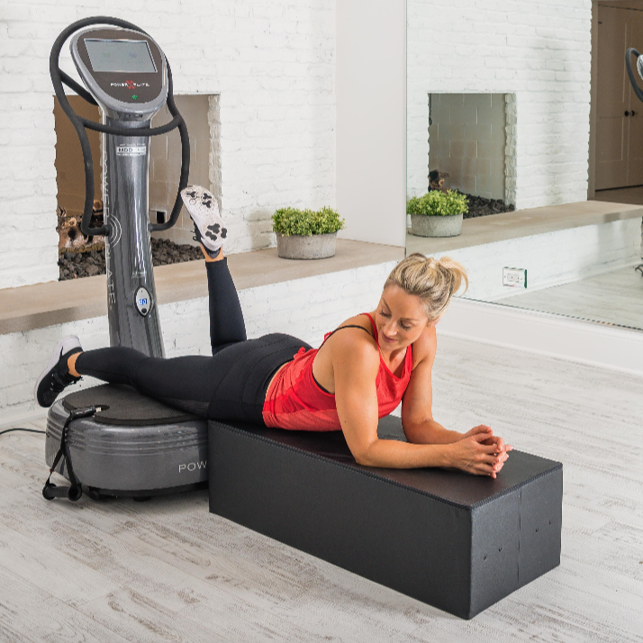 Power Plate Large Support Cushion vibration training accessory supporting prone exercise beside Power Plate platform in studio gym