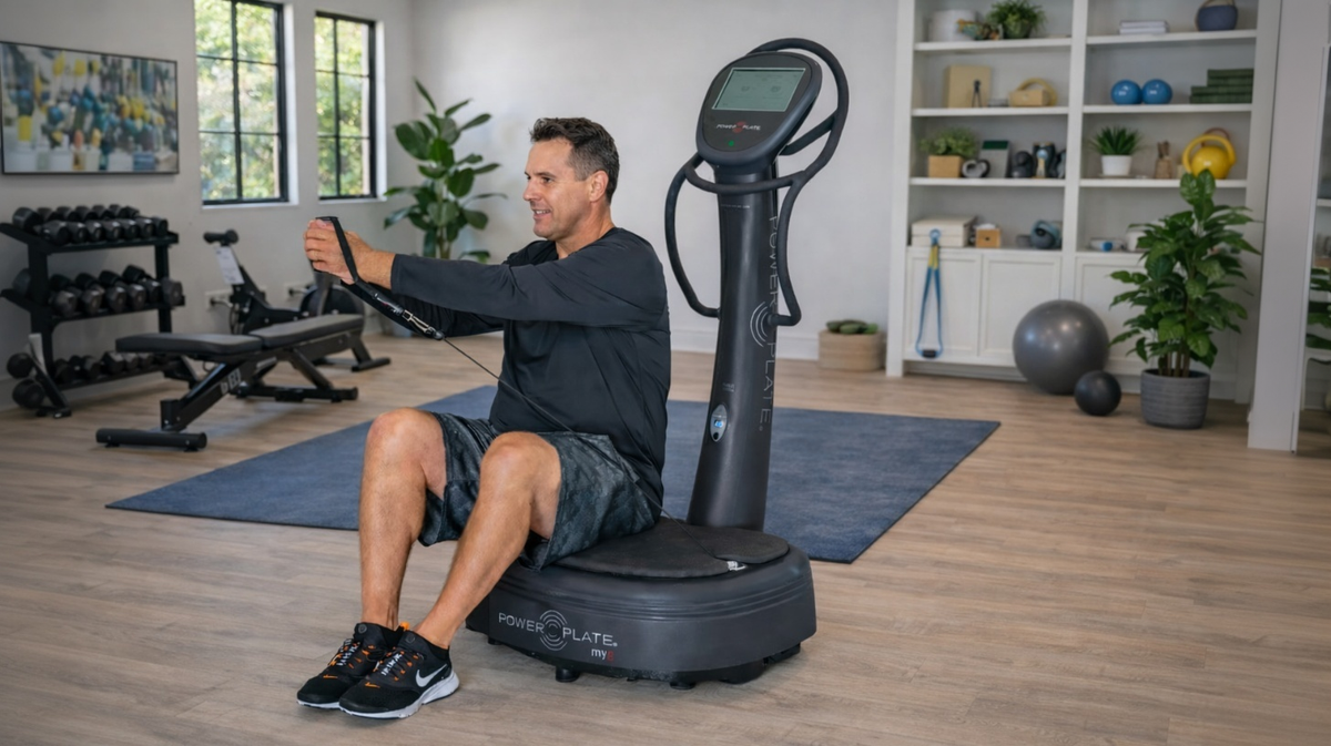 Power Plate my8 whole body vibration platform used for seated resistance cable exercise in professional home gym training environment
