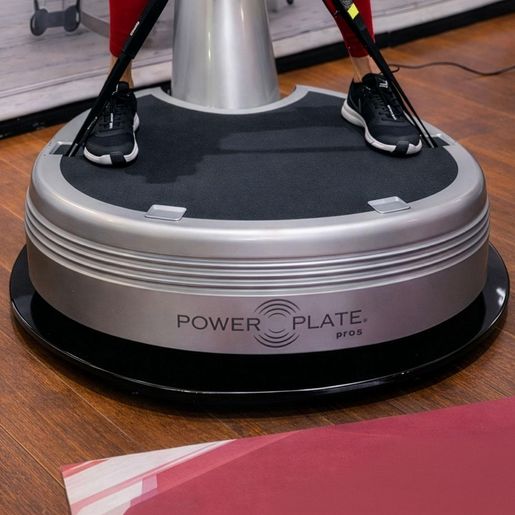 Power Plate pro5 vibration platform installed on Power Shield vibration reduction platform accessory on hardwood floor training environment