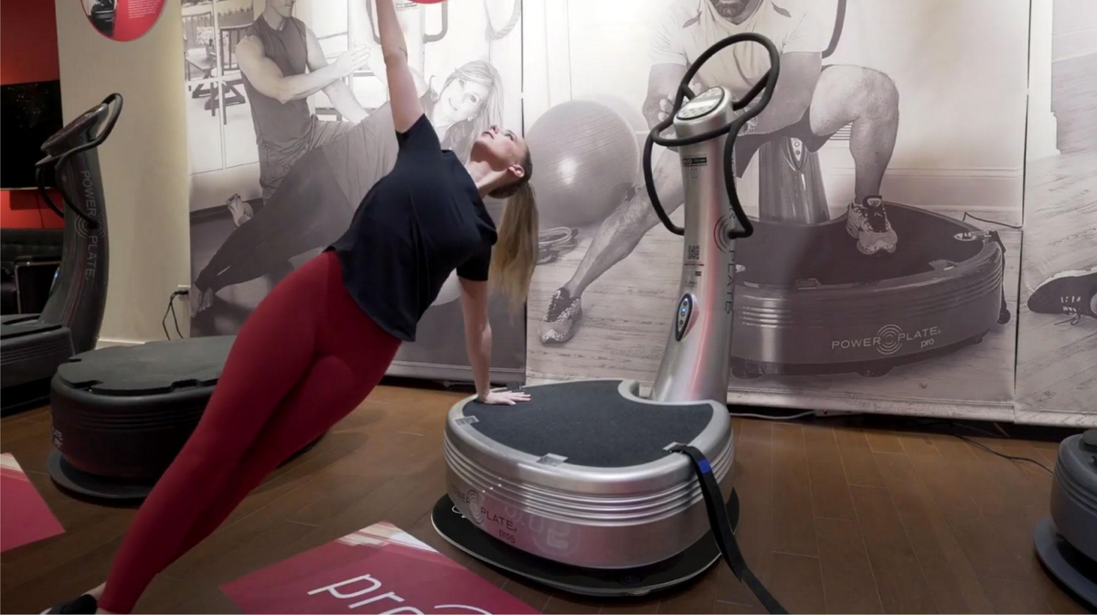 User exercising on Power Plate pro5 vibration platform installed on Power Shield vibration reduction platform during whole body vibration training