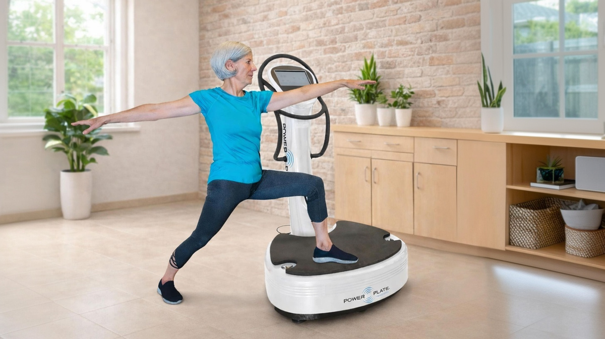 Power Plate pro7HC healthcare vibration platform patient performing balance exercise in physical therapy clinic environment