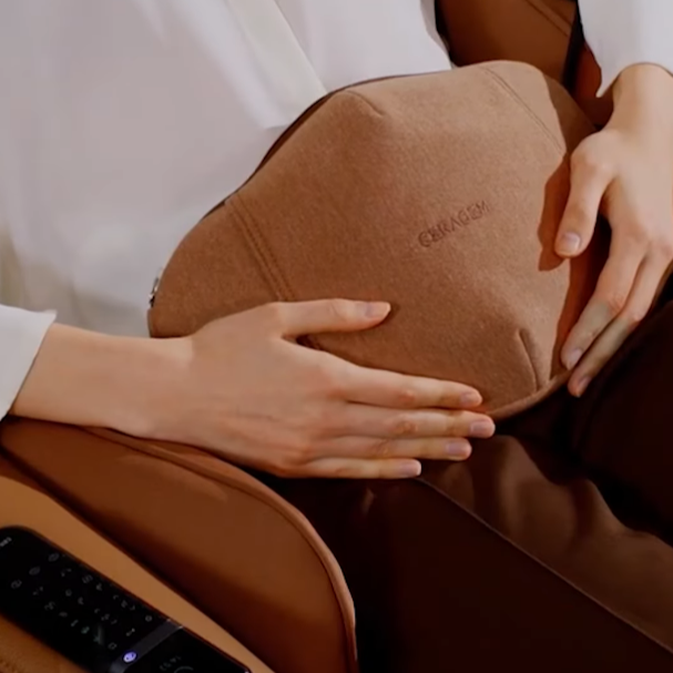 Ceragem Pause M4 massage chair heated abdominal massager applied to user while seated