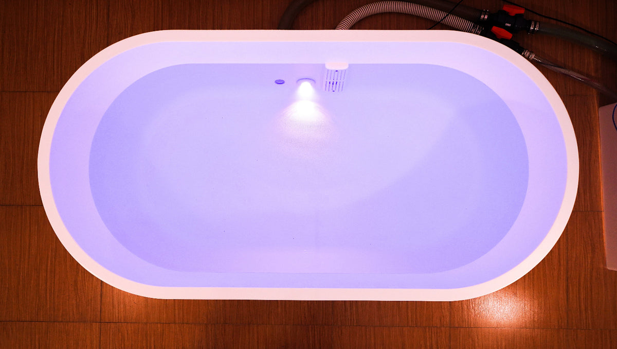 Dreampod Home Float Pro float tank top-down view with open interior showing illuminated water chamber