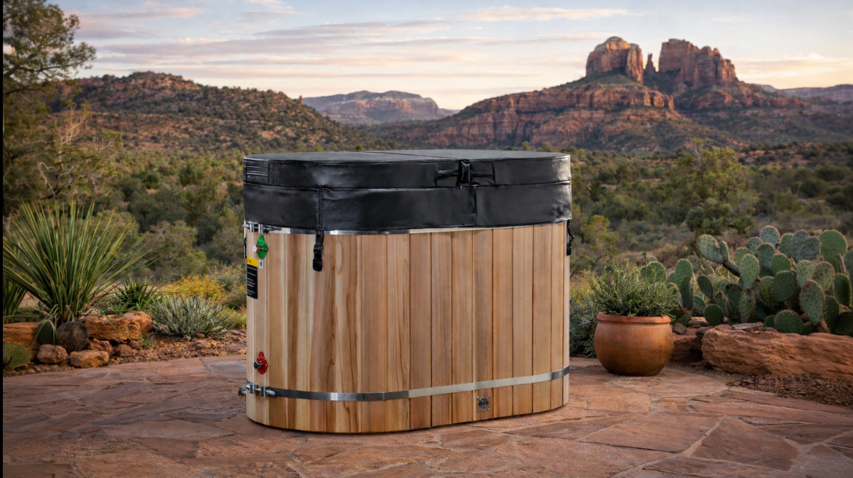 Dynamic Cold Therapy oval cold plunge tub with insulated cover placed outdoors in desert landscape with red rock mountains