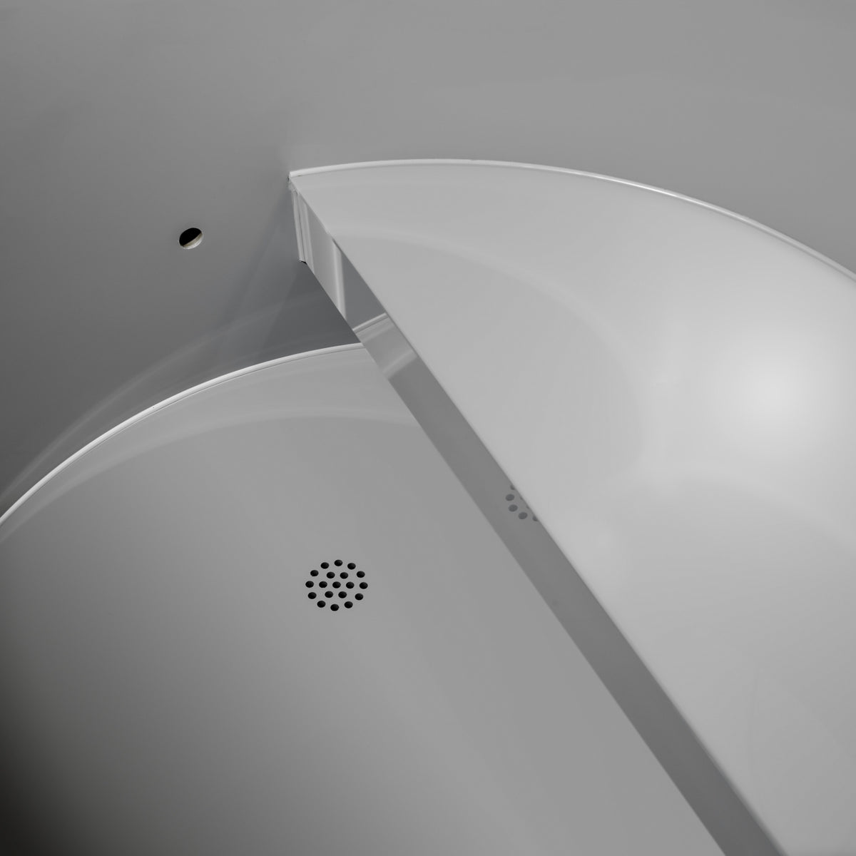 Dynamic Cold Therapy oval cold plunge tub PVC interior with integrated seat and floor drain in empty tub view