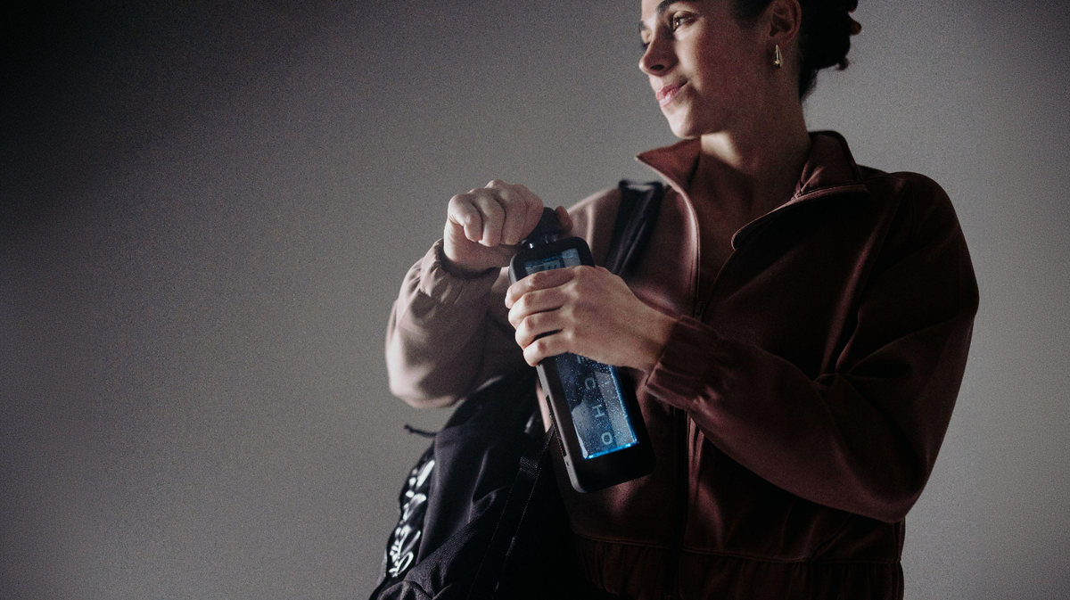 Echo Flask hydrogen water bottle being opened by user in everyday lifestyle setting with active hydration use