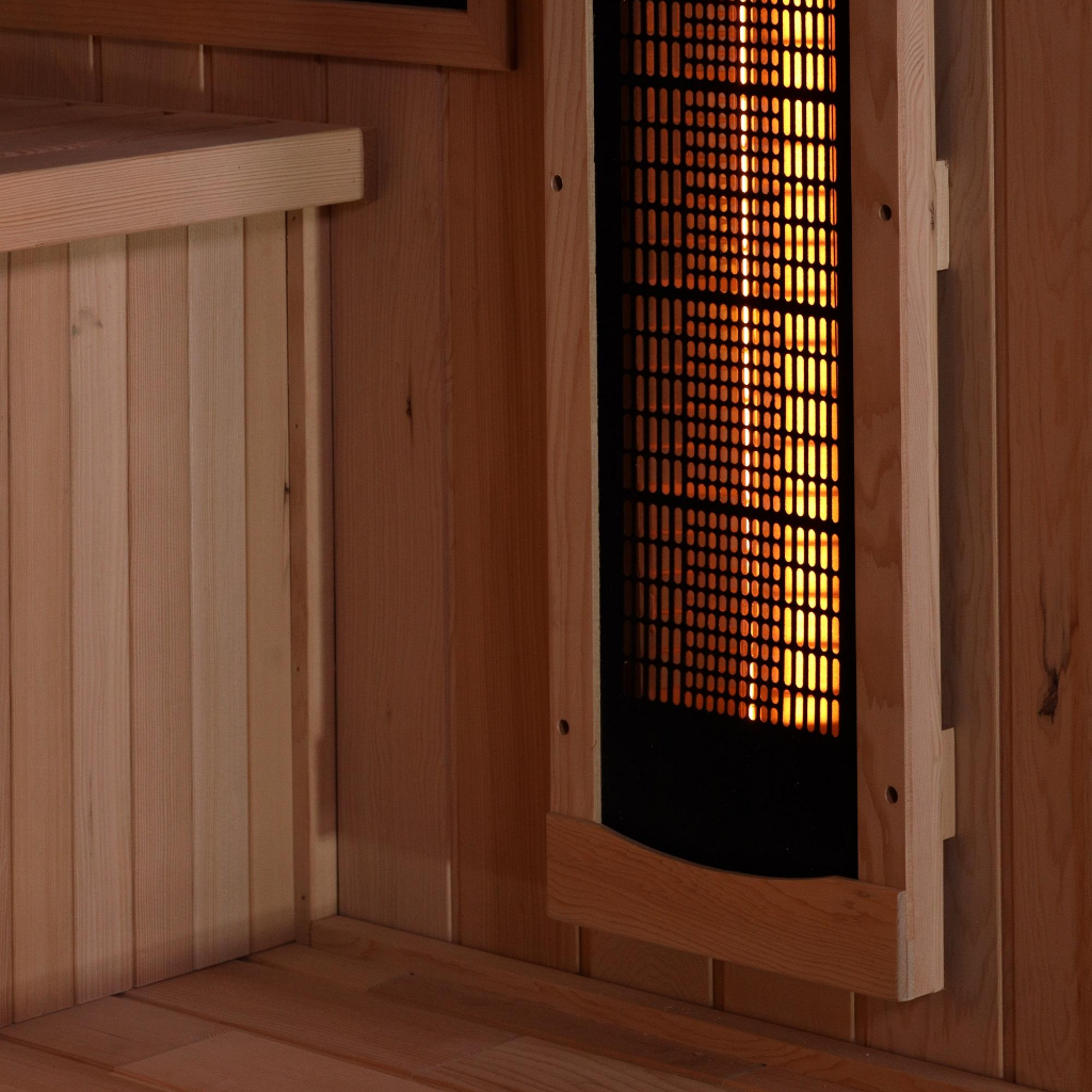 Golden Designs Reserve Edition infrared sauna near infrared heater panel emitting visible heat inside interior cabin with wood bench and wall panel construction