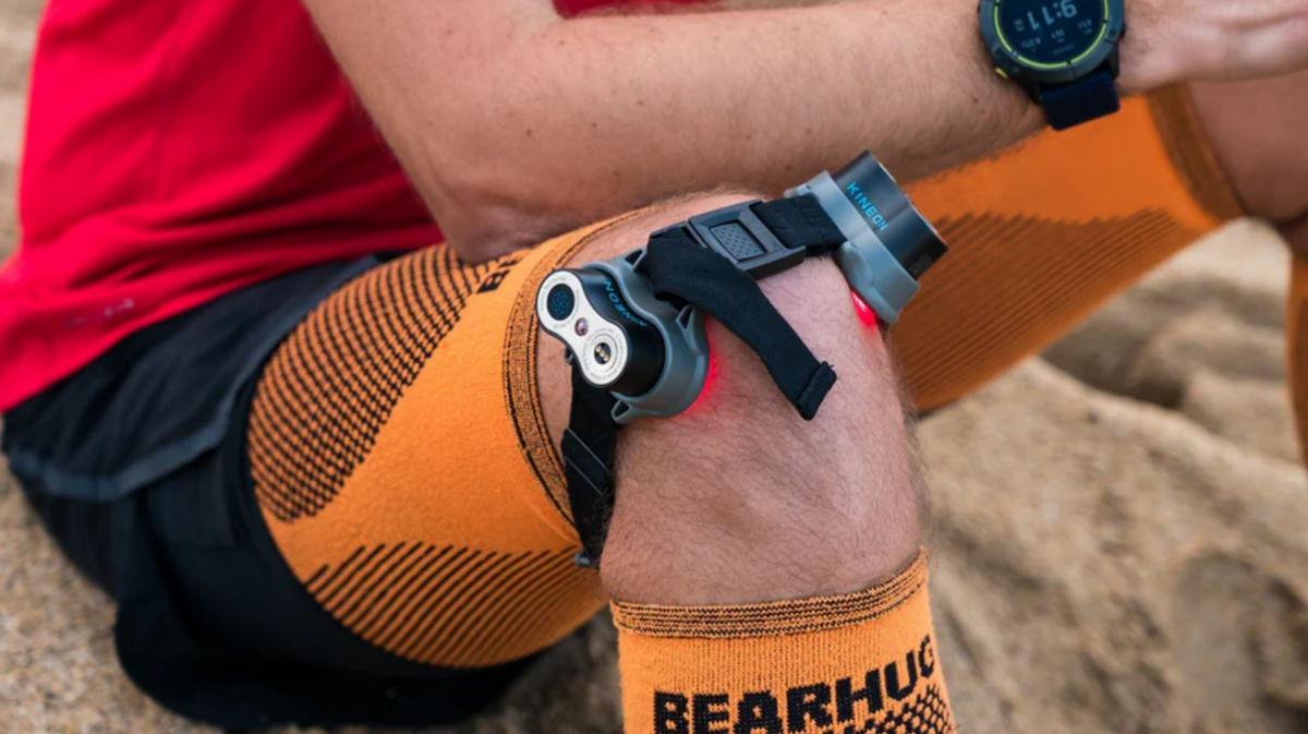 Kineon MOVE+ wearable red light therapy device applied to knee during outdoor activity supporting joint recovery and mobility use
