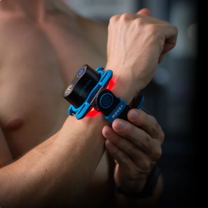 Kineon MOVE+ wearable red light and laser therapy device applied to wrist joint during indoor use
