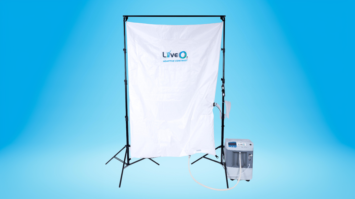 LiveO2 Adaptive Contrast EWOT system reservoir and air separator with tubing on a blue studio background