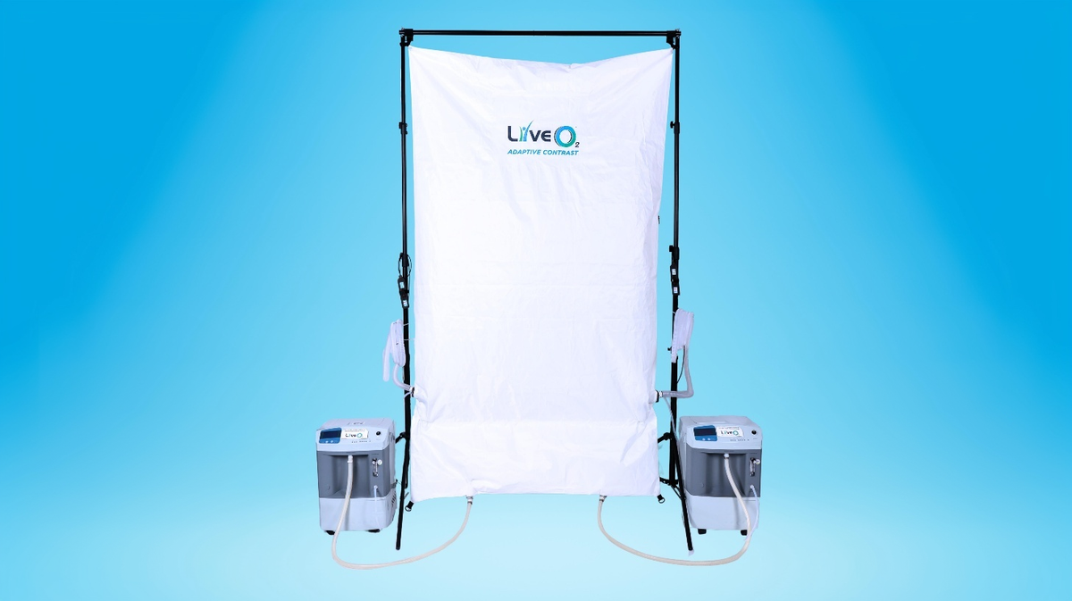 LiveO2 Dual-User Adaptive Contrast EWOT system with Dual AC reservoir, dual air separators, and tubing on a blue studio background