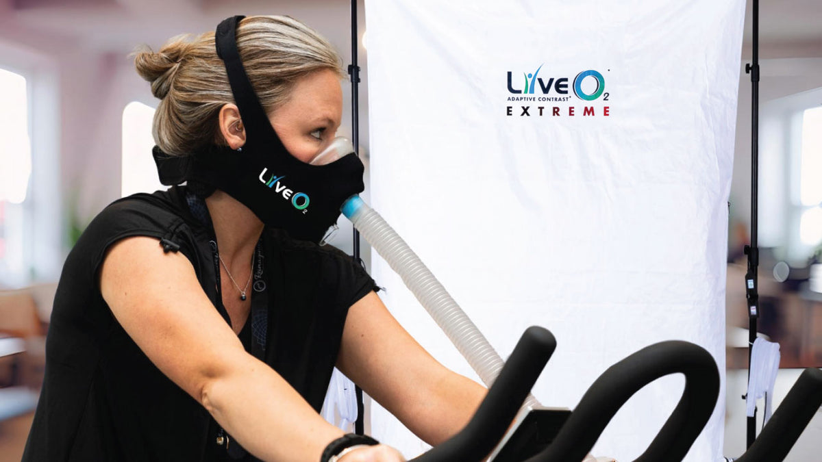 LiveO2 Extreme standard neoprene mask kit worn by woman during exercise with oxygen therapy bike session