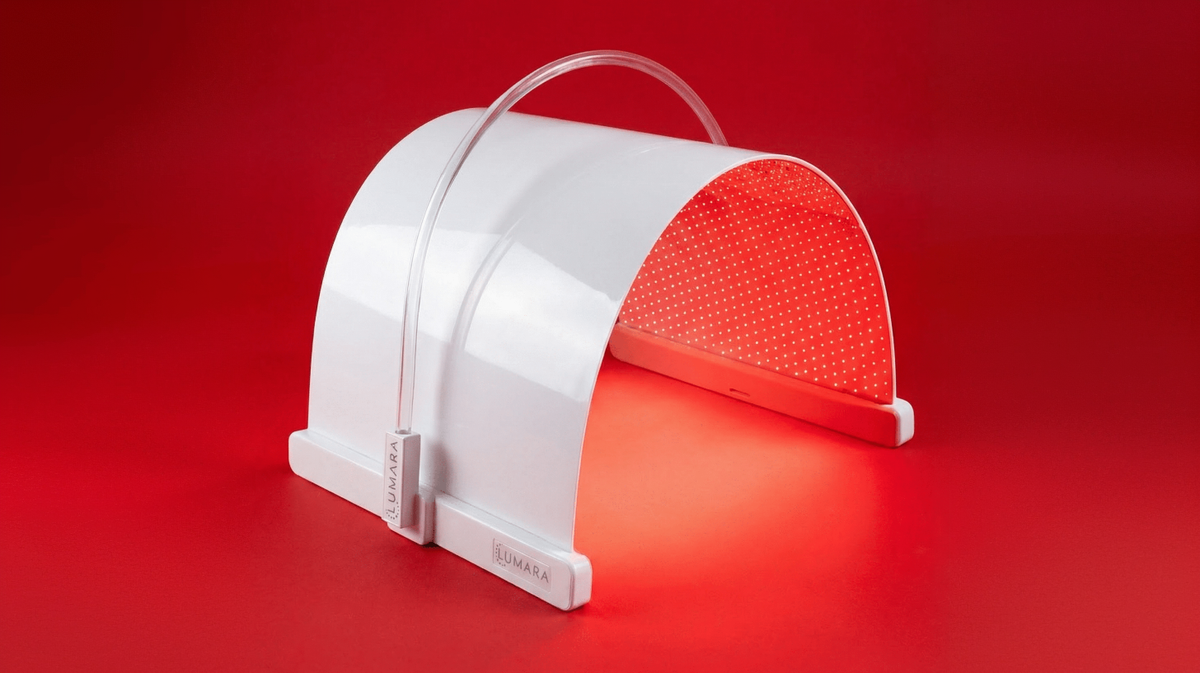 Lumara Illuminate V2 red light therapy panel flexible design illuminated on red background