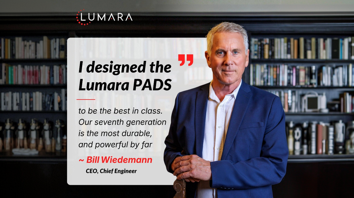 Lumara red light therapy pad product designer presenting device in professional indoor environment