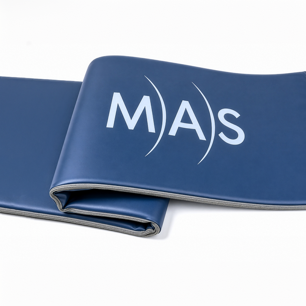 Close-up of folded MAS analog PEMF therapy mat with embossed logo and flexible full-body wellness mat construction