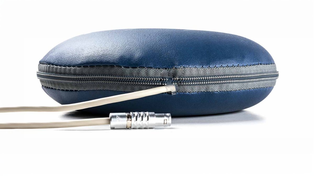 Side profile of MAS analog PEMF targeted applicator showing zippered housing, connection cable, and compact therapy pad construction