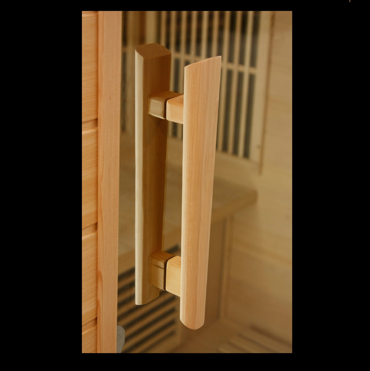 Maxxus Toulouse infrared sauna glass door handle detail showing solid wood grip and tempered glass door construction in indoor sauna setting