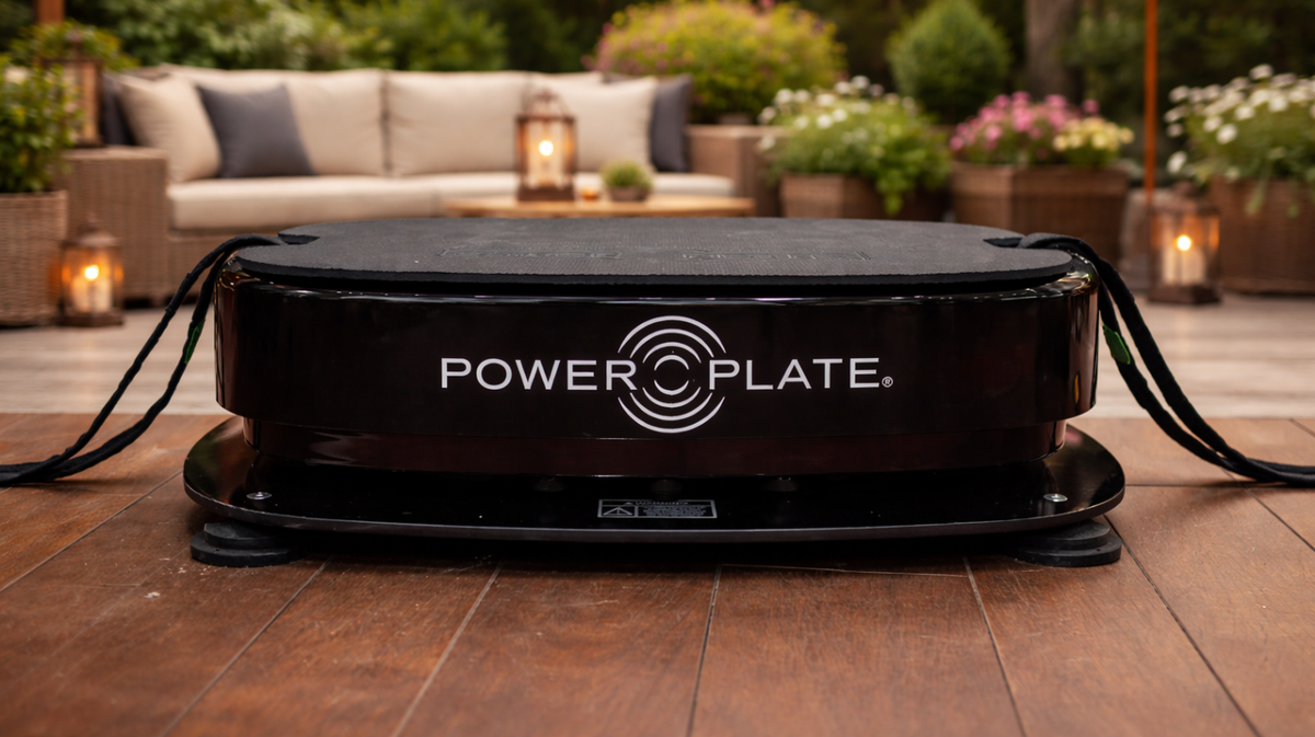 Personal Power Plate vibration trainer positioned on the Personal Power Shield platform demonstrating how the vibration reduction base sits beneath the machine to help limit vibration transfer in home or patio workout environments.