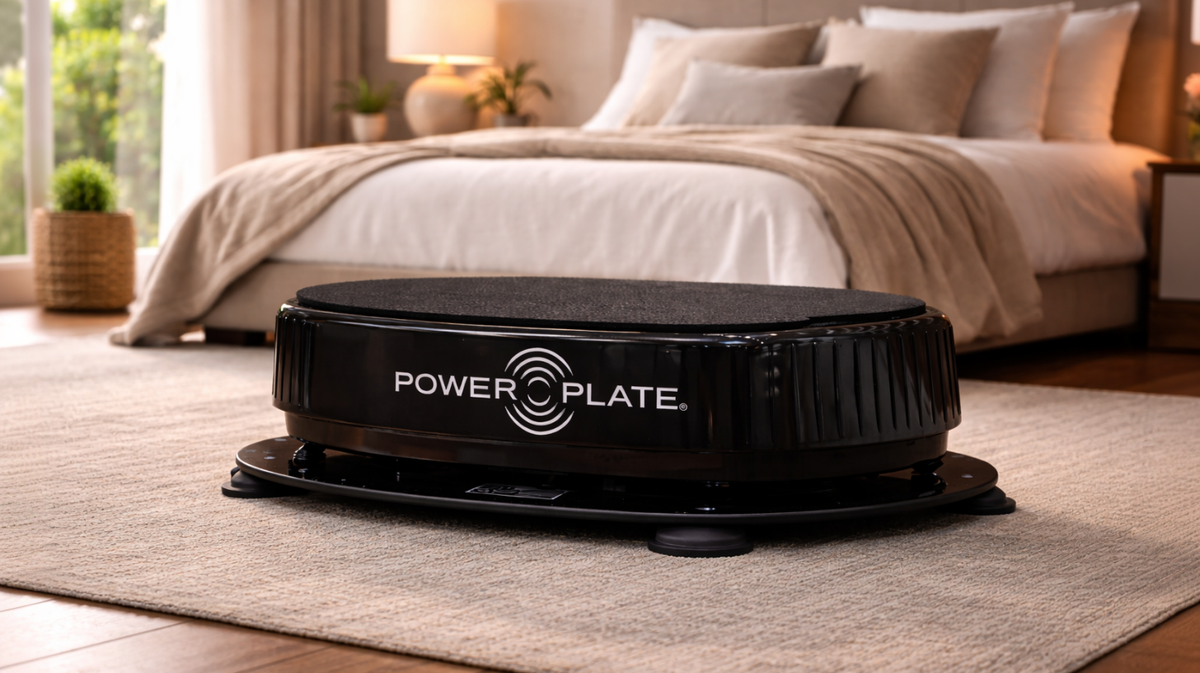 Personal Power Plate vibration trainer positioned on the Personal Power Shield platform demonstrating how the vibration reduction base sits beneath the machine to help limit vibration transfer in home workout environments.