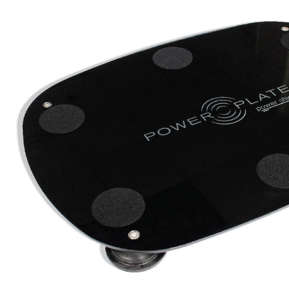 Detail view of the Personal Power Plate Power Shield vibration damping base positioned beneath the Personal Power Plate platform showing how the shield helps disperse residual vibration through the floor surface during training.