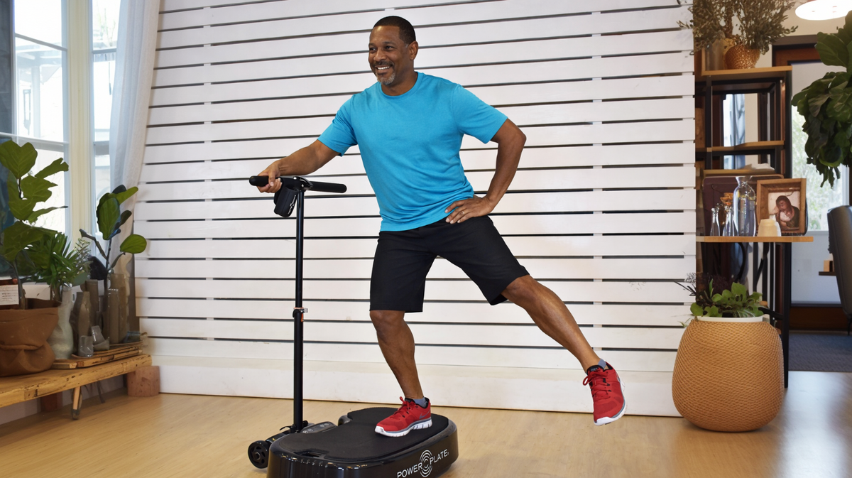 Personal Power Plate Stability Bar providing balance support while a user performs standing exercises on the Personal Power Plate whole body vibration training platform