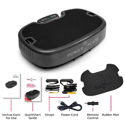 Personal Power Plate vibration platform with included straps, remote control, rubber mat, power cord, and instruction materials for whole body vibration training.