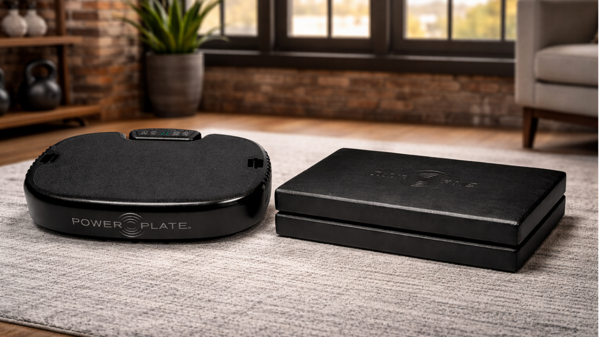 Personal Power Plate vibration platform positioned beside the Folding Support Cushion demonstrating a typical recovery setup where the cushion elevates the user to platform height during vibration-assisted massage and mobility routines.