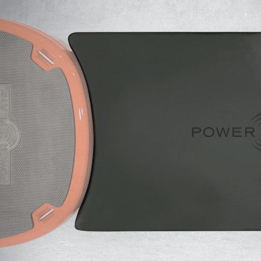 Top view close up comparison of Power Plate Deluxe Support Cushion positioned next to vibration platform showing extended support surface for exercises