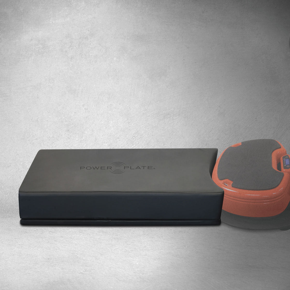 View of Power Plate Deluxe Support Cushion positioned beside vibration platform illustrating accessory fit and positioning