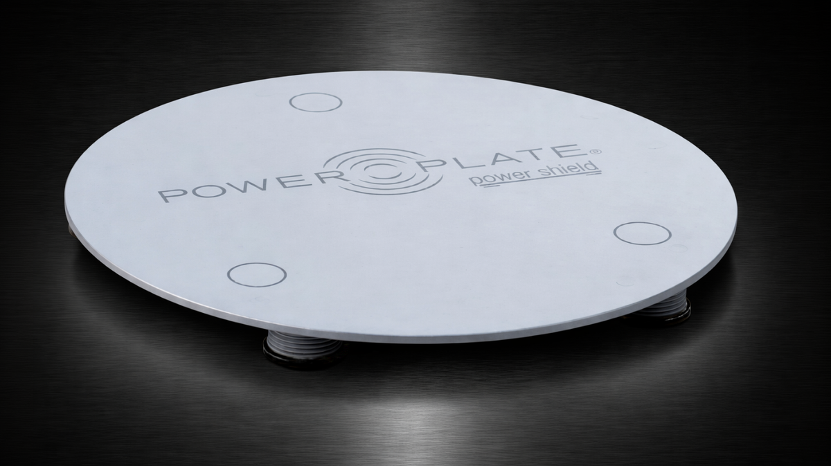 Power Plate my5 Power Shield vibration isolation platform accessory shown on dark background designed to reduce vibration transfer beneath Power Plate my5 systems
