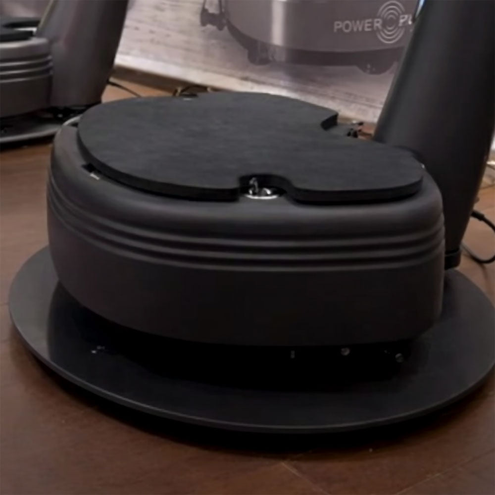 Close-up of Power Plate my7 my8 Power Shield base showing vibration isolation feet and structural support elements designed to reduce floor vibration transfer