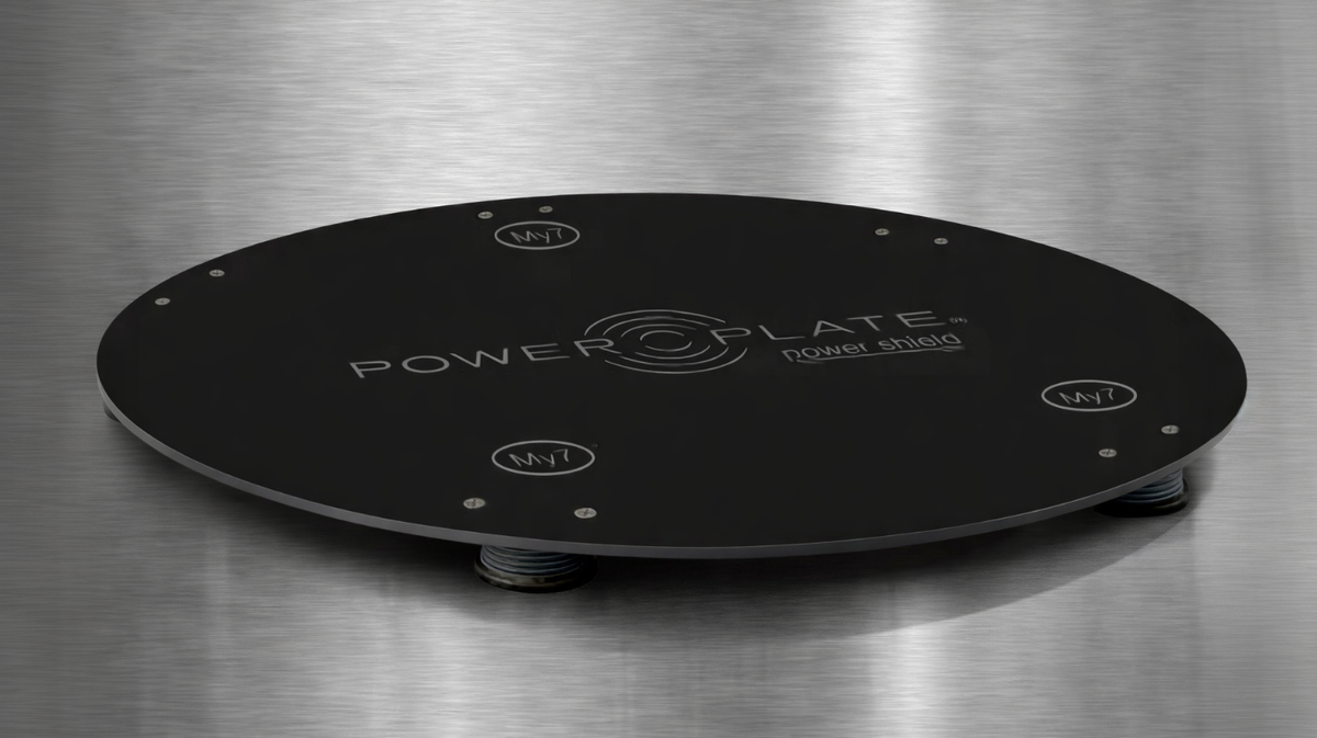 Power Plate my7 my8 Power Shield gloss black vibration reduction platform displayed on metallic surface highlighting low profile structure and floor protection design