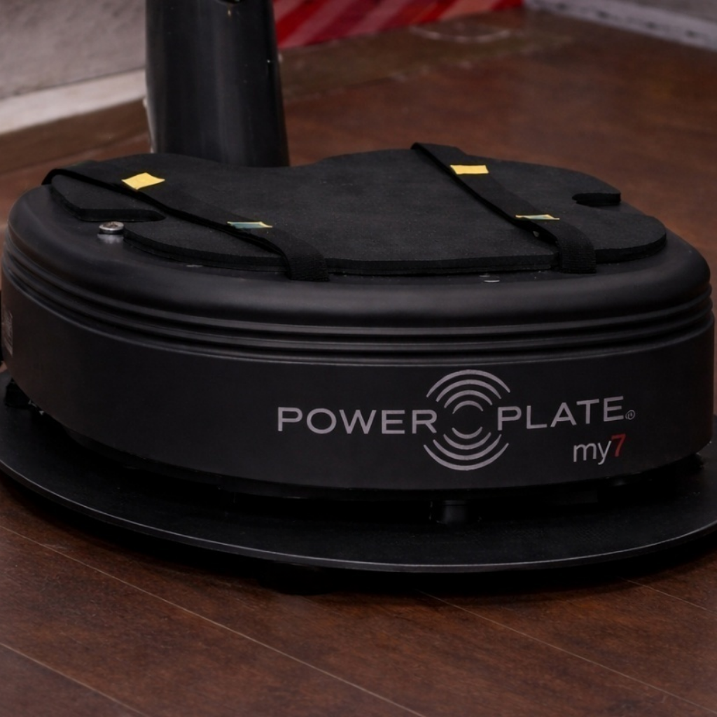 Power Plate my7 vibration platform mounted on Power Shield base with support cushion attached showing complete vibration reduction setup for controlled training environment
