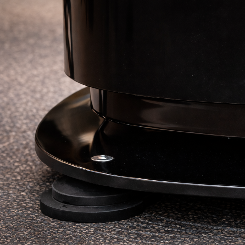 Close-up view of vibration isolation feet on the Personal Power Plate Power Shield platform demonstrating how the base disperses residual vibration energy to help reduce vibration transfer through floors during vibration training.