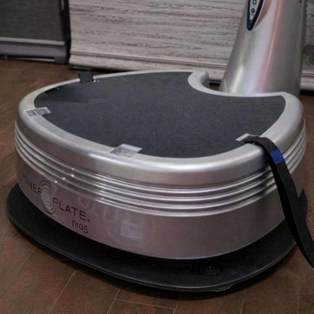 Close-up of Power Plate pro5 Power Shield vibration reduction platform showing accessory positioned beneath vibration training equipment