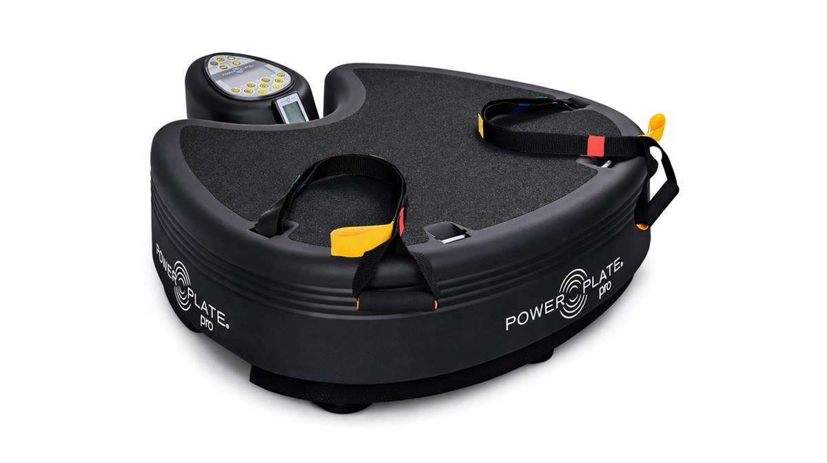 Power Plate pro5 whole body vibration platform with integrated resistance straps on studio background