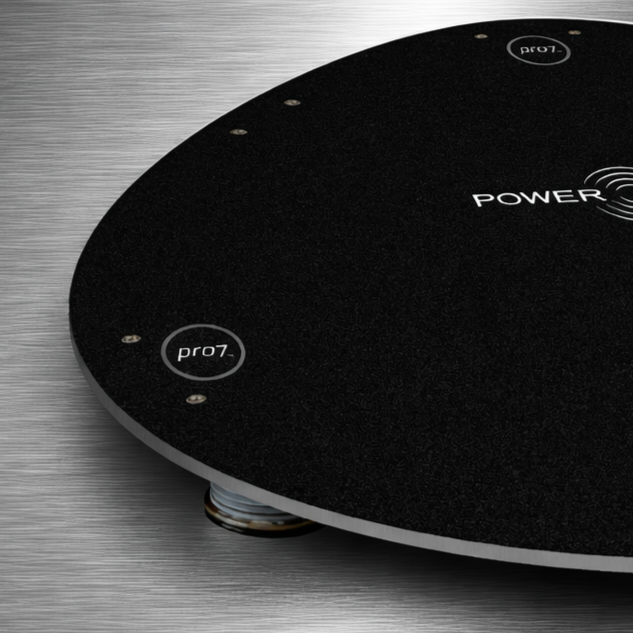 Close-up of Power Plate pro7 pro8 Power Shield surface and edge detail showing textured platform finish and vibration isolation foot beneath base on metallic background