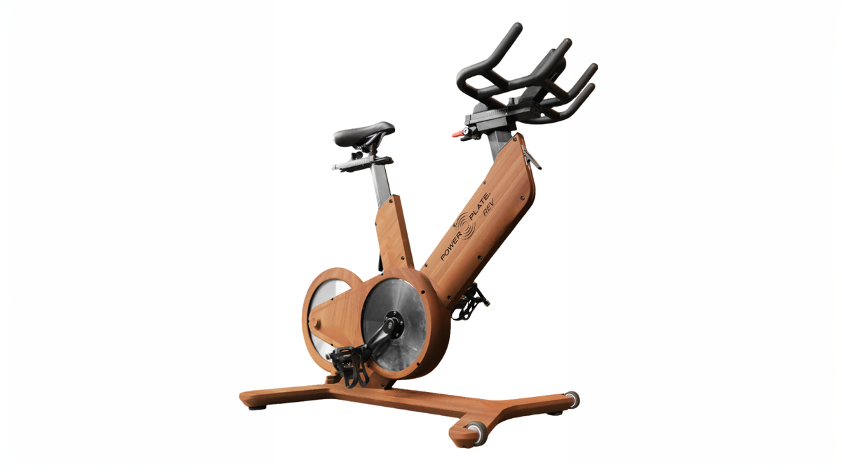 Power Plate REV bike vibration indoor cycle with VibeShift Technology wood finish exercise bike side view