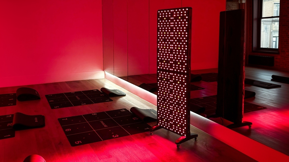 Renew Red Light Max Panel red light therapy panel positioned in gym recovery environment with training equipment